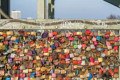 Low angle view of padlocks hanging on railing