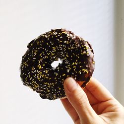 Close-up of hand holding a donut