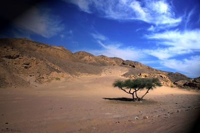Scenic view of mountains against cloudy sky