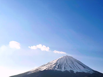 Scenic view of mountains against blue sky