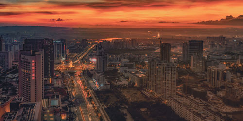 High angle view of modern buildings against sky during sunset