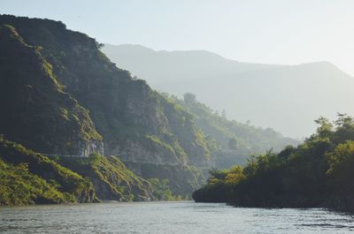 Scenic view of lake and mountains against sky