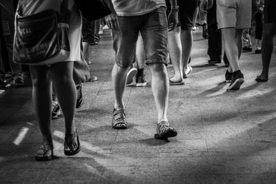 Low section of people walking on street