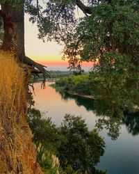 Scenic view of lake against sky at sunset