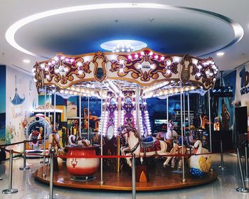 Illuminated carousel in amusement park