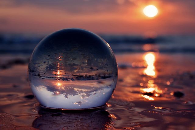 Close-up of crystal ball on beach against | ID: 151855964