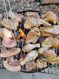 High angle view of meat on barbecue grill