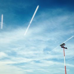 Low angle view of floodlight against blue sky