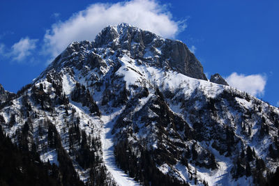 Low angle view of snowcapped mountains against sky