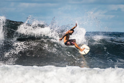 Man surfing waves in atlantic ocean, tenerife, spain