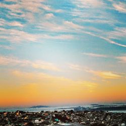 Aerial view of city against sky during sunset