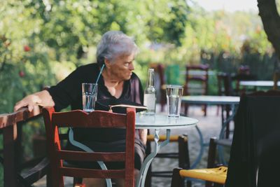 Woman sitting on table at restaurant