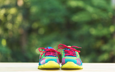 Low section of multi colored shoes on wooden table