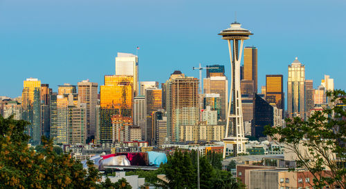 Buildings in city against clear sky