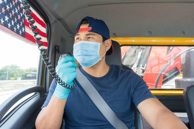 Portrait of man sitting in car