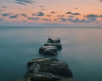 Scenic view of sea against cloudy sky