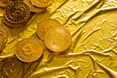 Close-up of bitcoins on golden paper