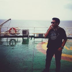 Man standing by sea against clear sky