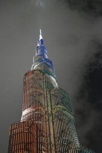 Low angle view of illuminated skyscraper