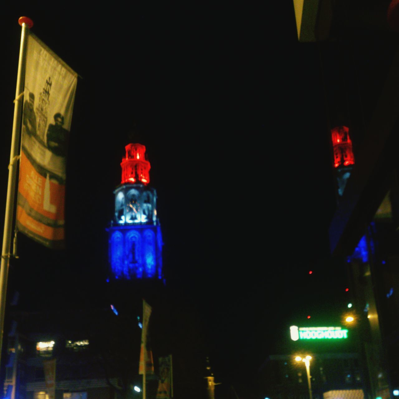 illuminated, night, low angle view, lighting equipment, red, architecture, built structure, copy space, building exterior, no people, street light, neon, clear sky, multi colored, lantern, light - natural phenomenon, electric light, city, outdoors, road signal