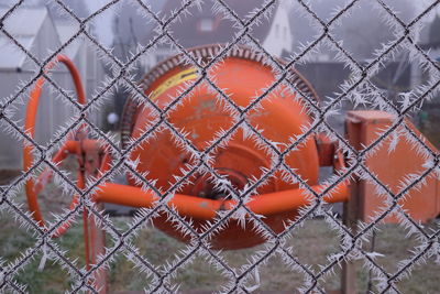 Full frame shot of machinery behind chainlink fence