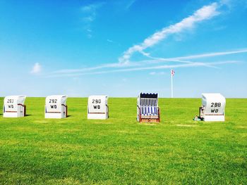 Information sign on field against sky