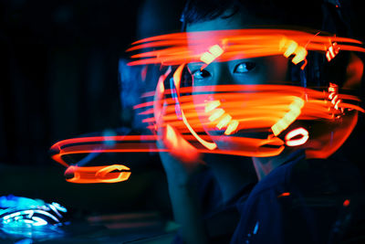 Digital composite portrait of boy by illuminated lights
