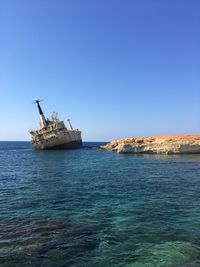 Scenic view of sea against clear blue sky