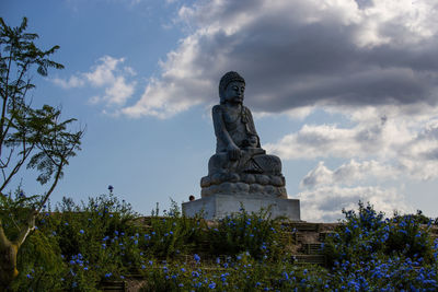 Low angle view of statue against sky