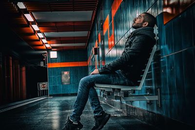 Low section of man sitting in trainstation 