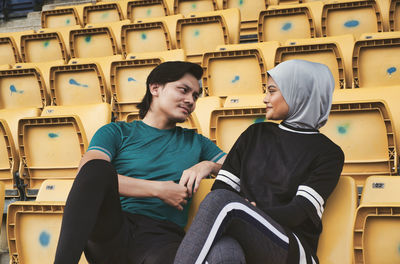 Young couple sitting on chair