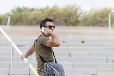 Side view of young man standing on field