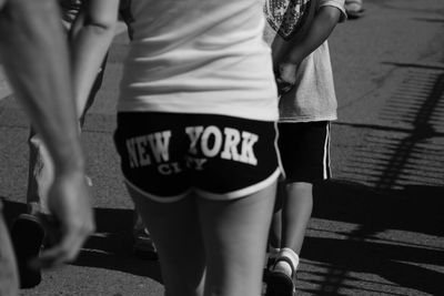 Low section of man and woman walking on road