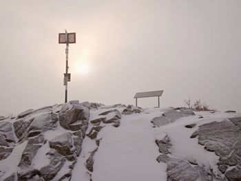 Slippery mountain tops in autumn covered with first snow and hidden in mist or cloud. danger weather