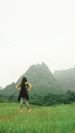 Full length of woman on field against clear sky