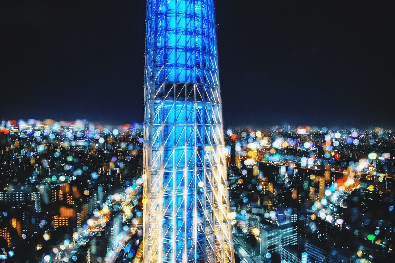 night, illuminated, architecture, built structure, city, building exterior, tall - high, sky, amusement park ride, cityscape, amusement park, no people, nature, motion, ferris wheel, travel destinations, tower, outdoors, skyscraper, office building exterior