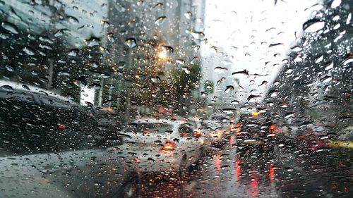 Raindrops on road seen through wet window