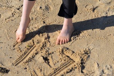 Low section of child on sand