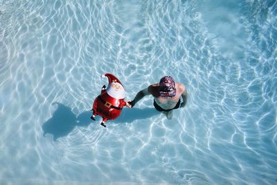 High angle view of siblings in swimming pool