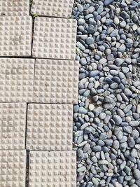 High angle view of pebbles and brick tile walkway or pathway.