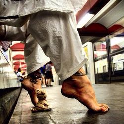 Low section of people walking on tiled floor