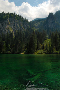 Scenic view of lake, trees reflecting in the emerald waters against dolomites