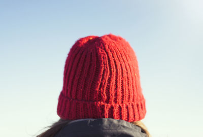 Rear view of person wearing hat against sky during winter