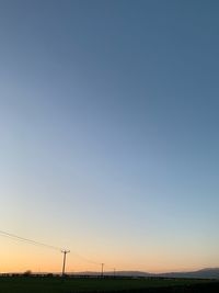 Scenic view of landscape against clear sky during sunset