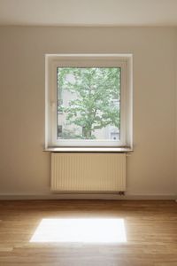 Window on wooden floor against wall