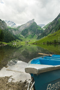 Boats in lake with mountains in background