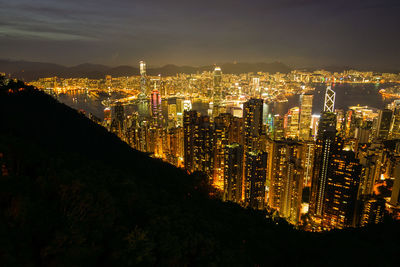 High angle view of illuminated buildings against sky at night