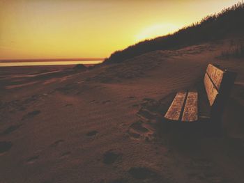 Scenic view of beach against clear sky during sunset