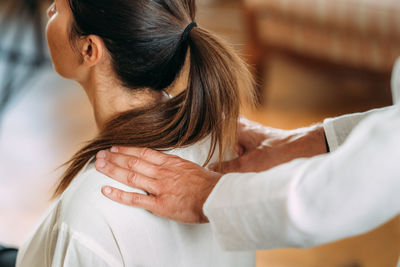 Woman enjoying shiatsu neck and shoulders massage.