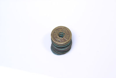 High angle view of coins on white background